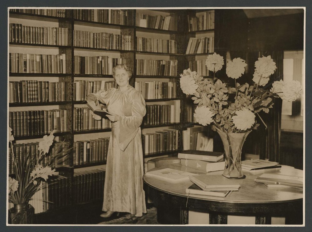 Louise Dyer standing in her personal library