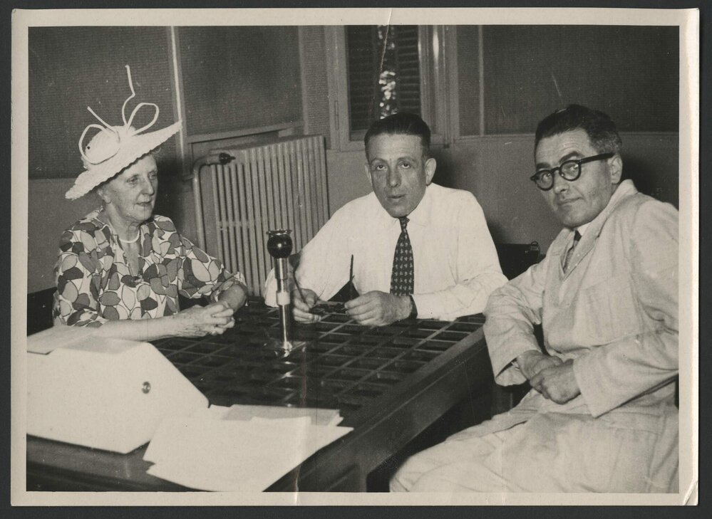 Louise Hanson-Dyer, Francis Poulenc and Jeff Hanson seated around an interview microphone in Strasbourg