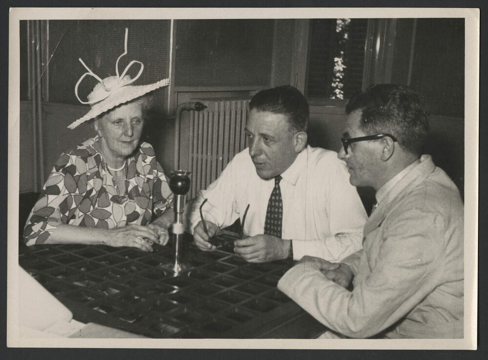 Louise Hanson-Dyer, Francis Poulenc and Jeff Hanson seated around an interview microphone in Strasbourg