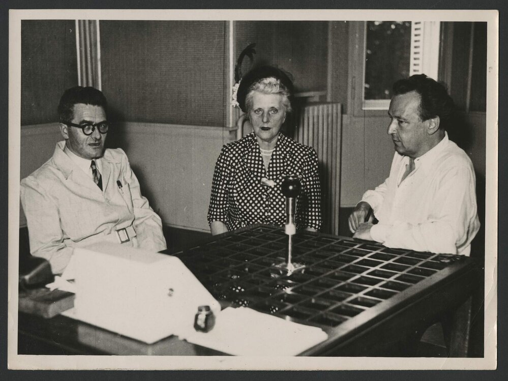 Jeff Hanson, Louise Hanson-Dyer and Arthur Honegger seated at an interview table in Strasbourg