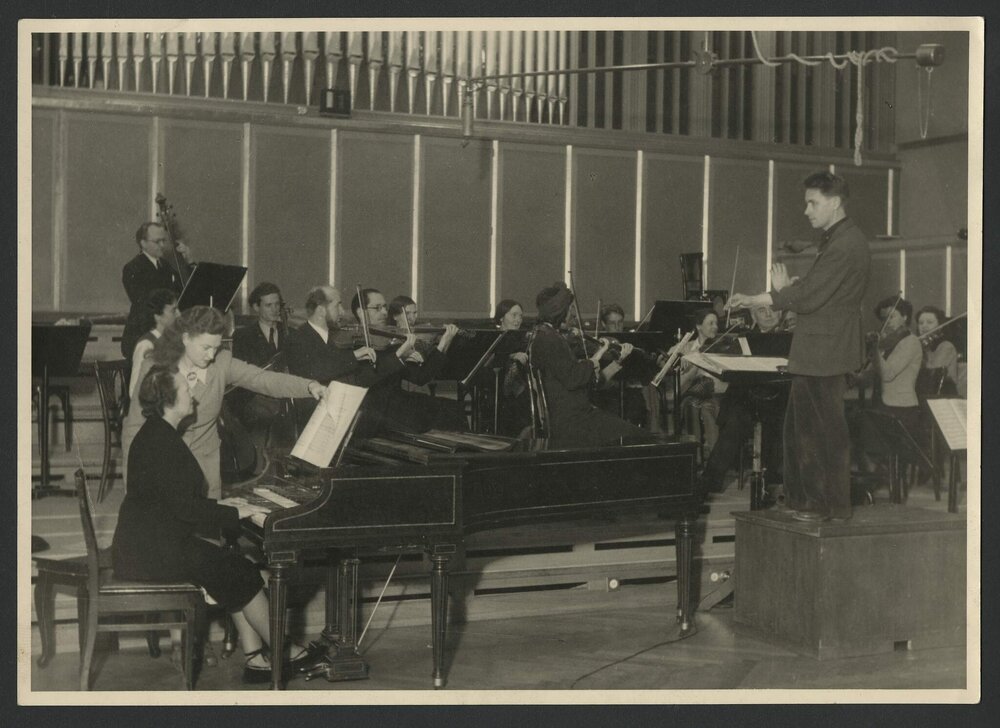 Swiss harpsichordist Isabelle Nef in a recording session with a small orchestra, conductor and page turner