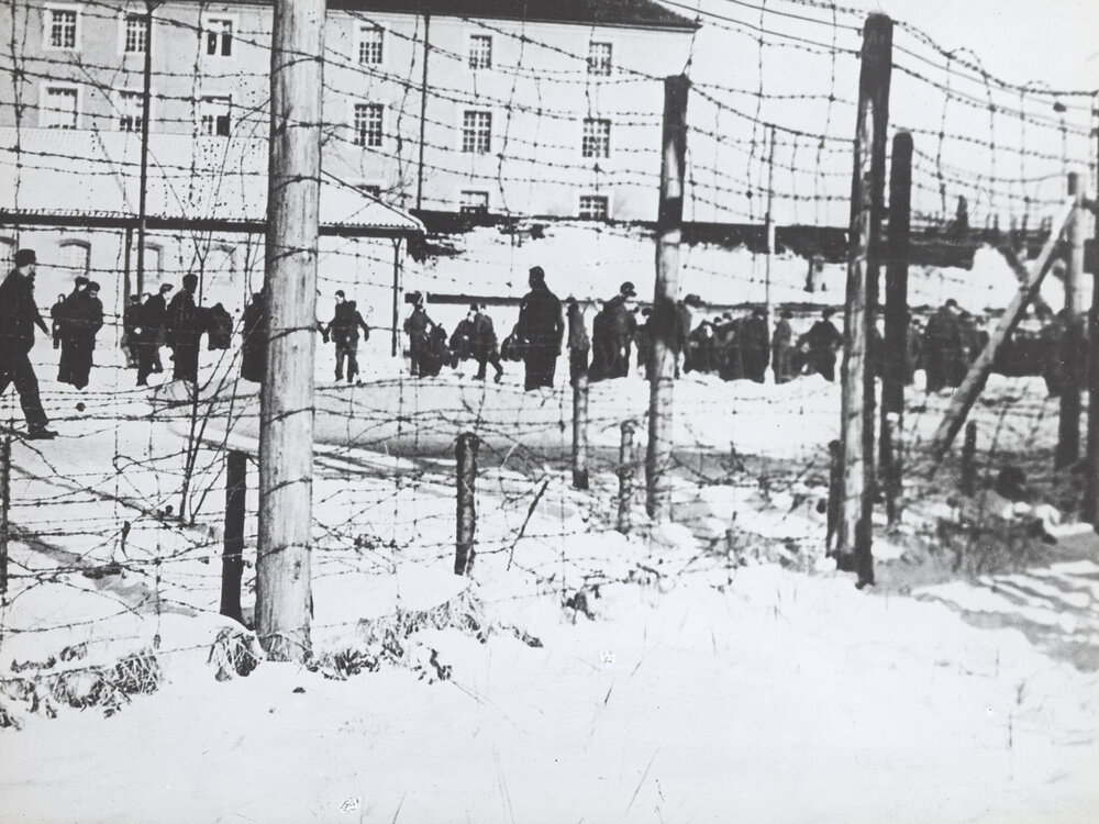 Unidentified prisoners of war camp: Group of men walking in the snow