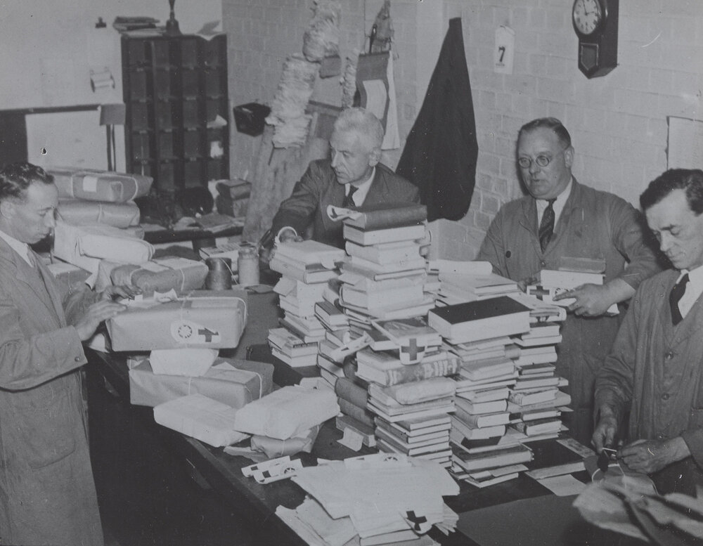 Packing books for POWs St. John and Red Cross labels