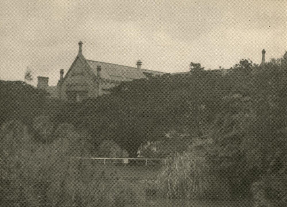 North-eastern corner of Main building with lake in foreground, University of Melbourne, circa 1936.
