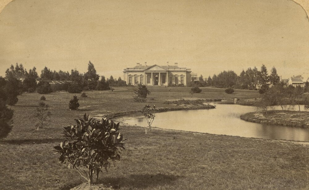 Old Medical building with lake and lawns in foreground, University of Melbourne.