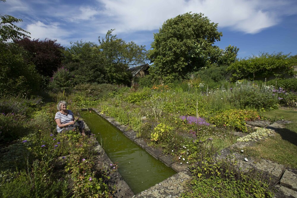 [Greer with garden and water feature]