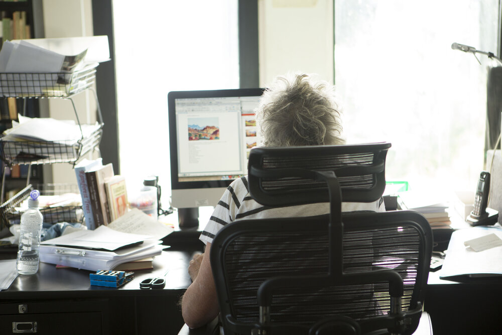 [Greer at desk from behind, Office]