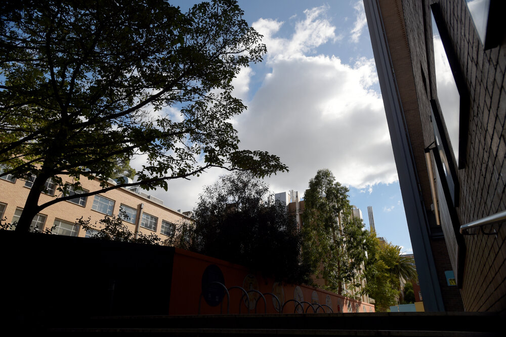 Parkville during COVID lockdown - Walkway and empty bike racks west side of Doug McDonell Building