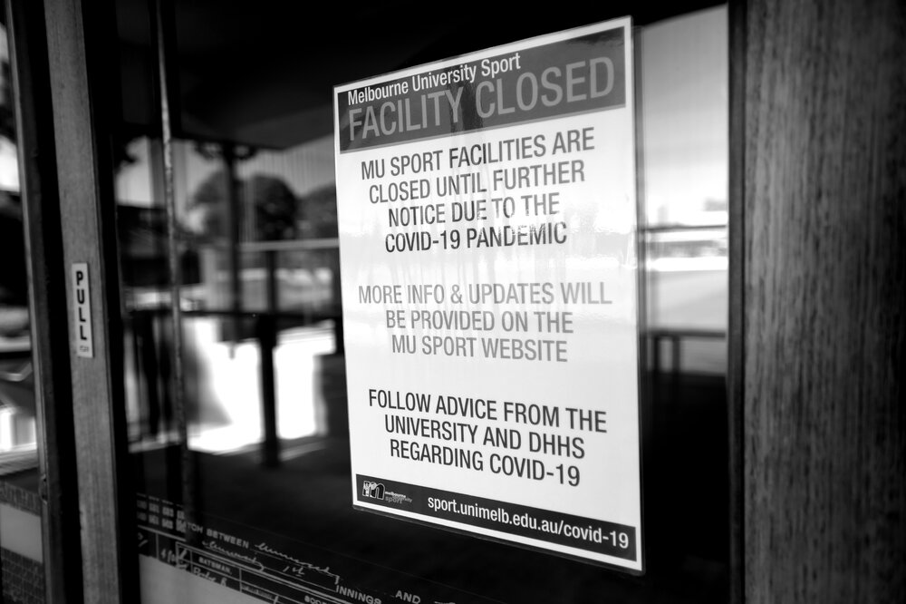 Parkville during COVID lockdown - MU Sports Ernie Cropley Sports Pavillion facility closure sign during stage 3 and 4 restrictions - Monochrome