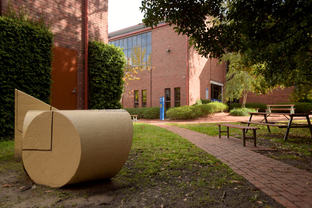 Southbank Campus during COVID lockdown - Friends Courtyard featuring sculpture - Performing Arts Dance Studios in background