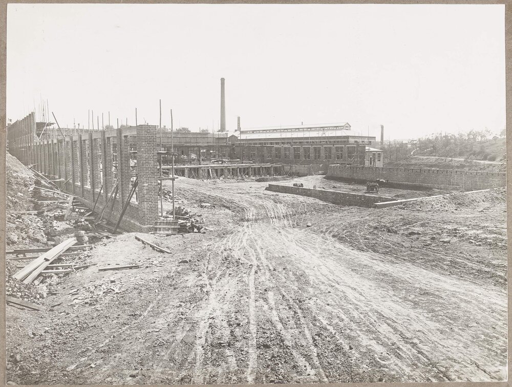 [Open muddy track leading into the Yarra Falls factory construction site]