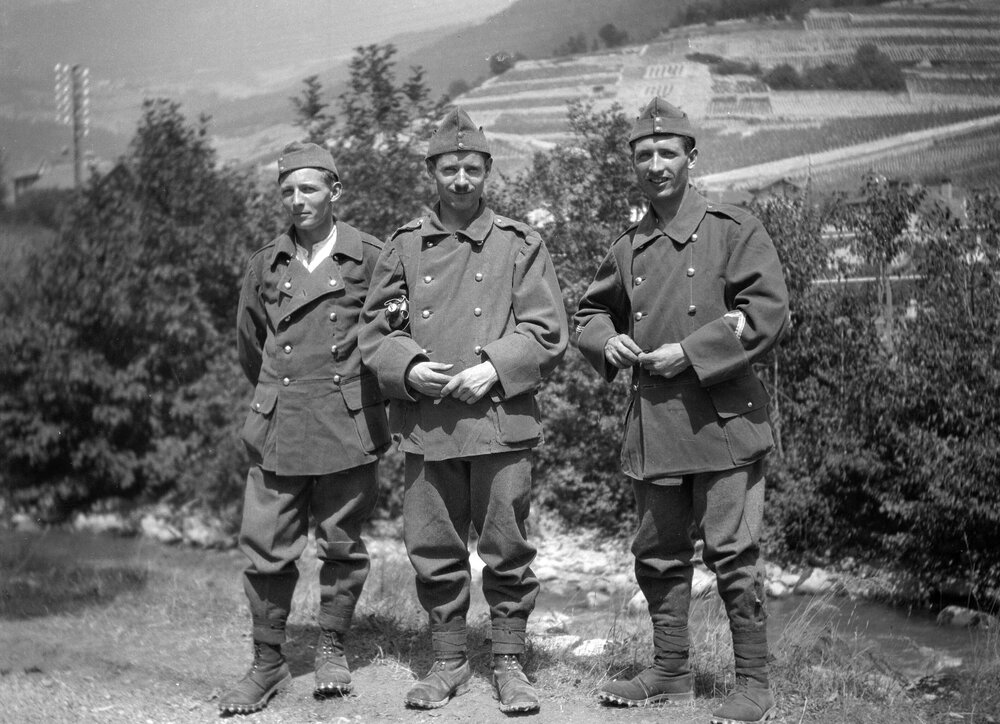 Three men dressed in military style clothing in or around Grangettes, Aigle or Chillon, Switzerland