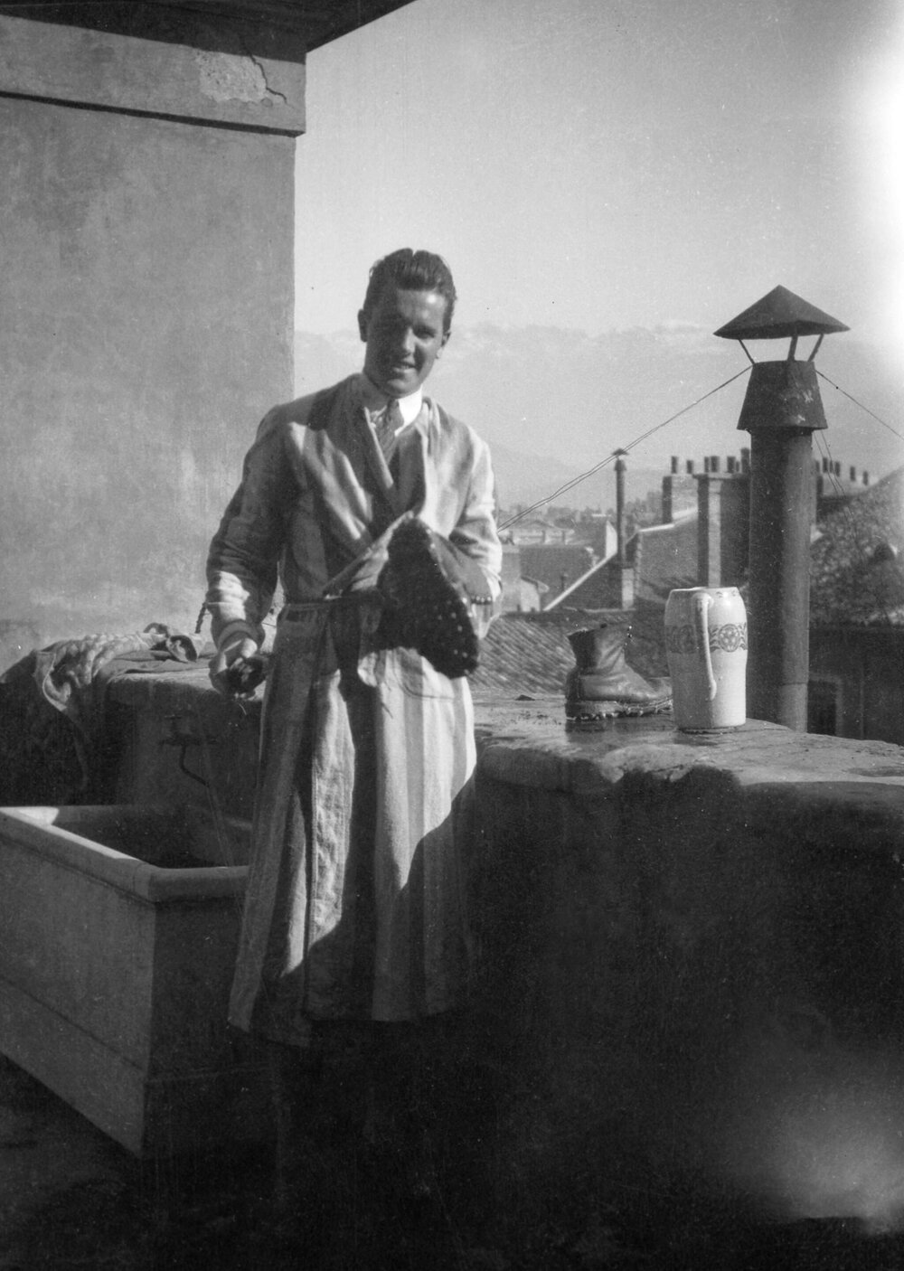 An unidentified man cleaning boots, possibly in Grenoble, France