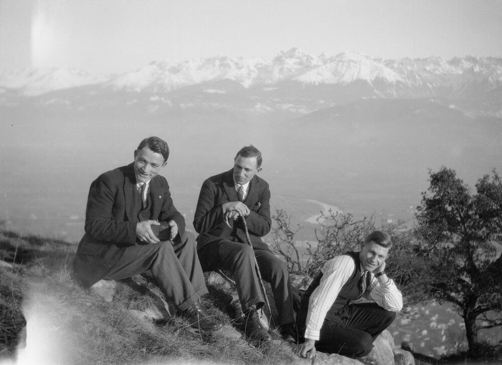 Three unidentified men and mountain scenery near Grenoble, France