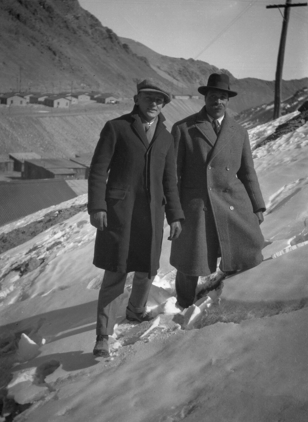 Two unidentified men standing (in snow?) in a Chilean desert