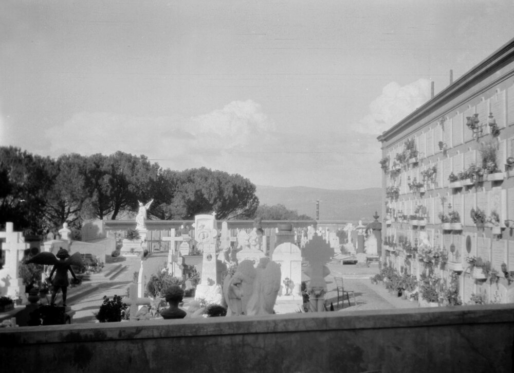 An unidentified graveyard and building in Italy