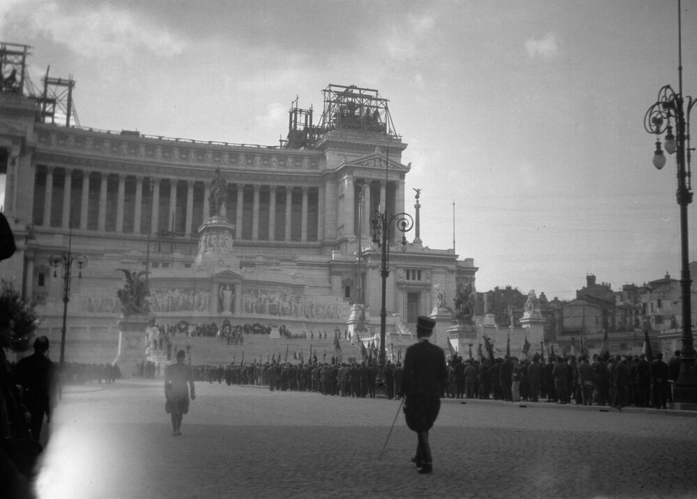 Men in military style uniforms parading in front of the Monumento Nazionale a Vittorio Emanuele II, Rome, Italy