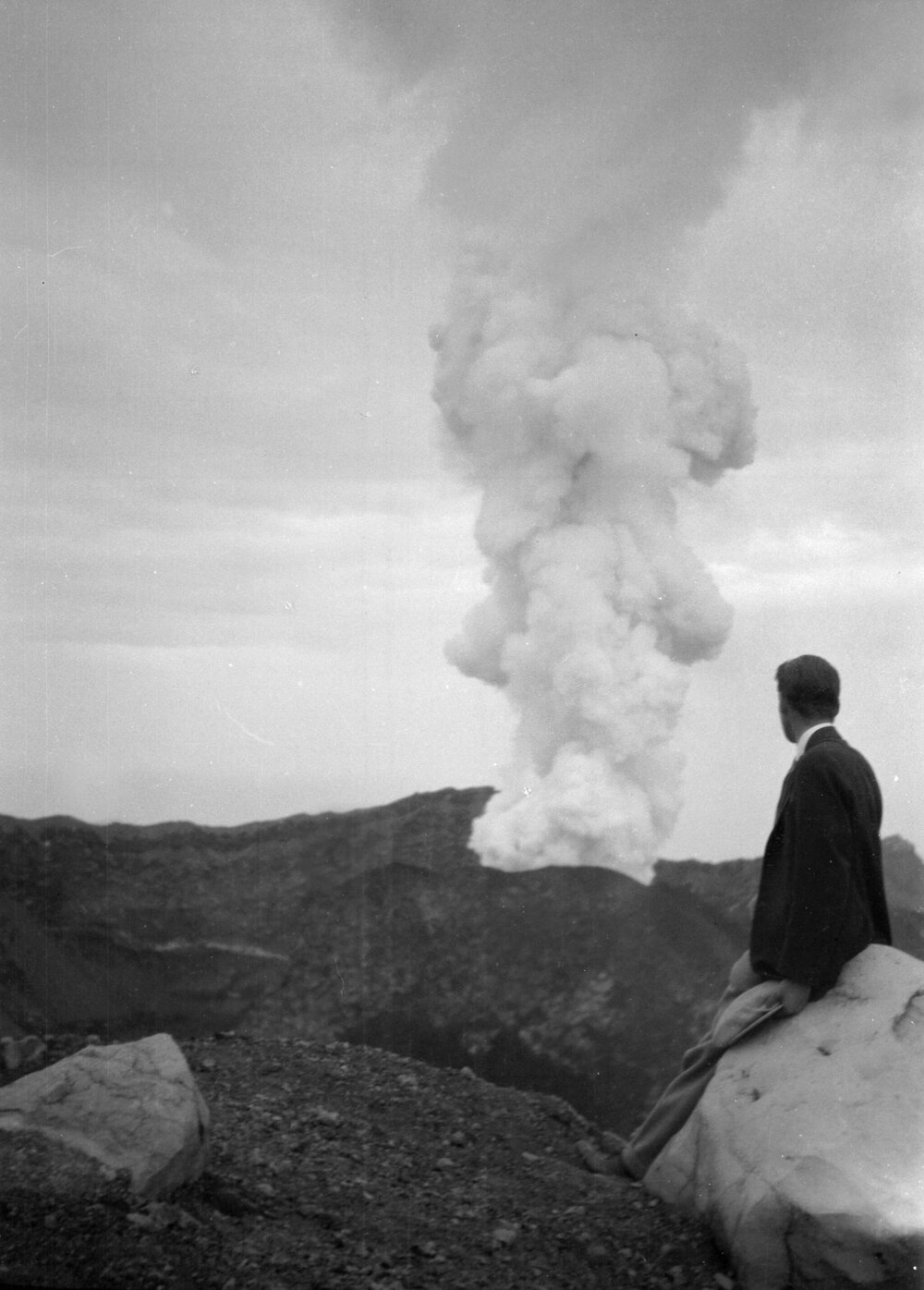 An unidentified man viewing an active volcano in Italy - probably Mount Vesuvius