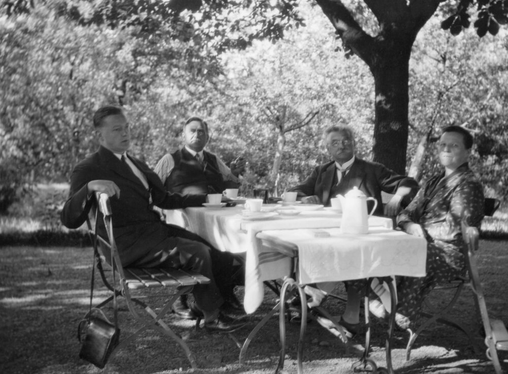 Four unidentified men gathered around a table