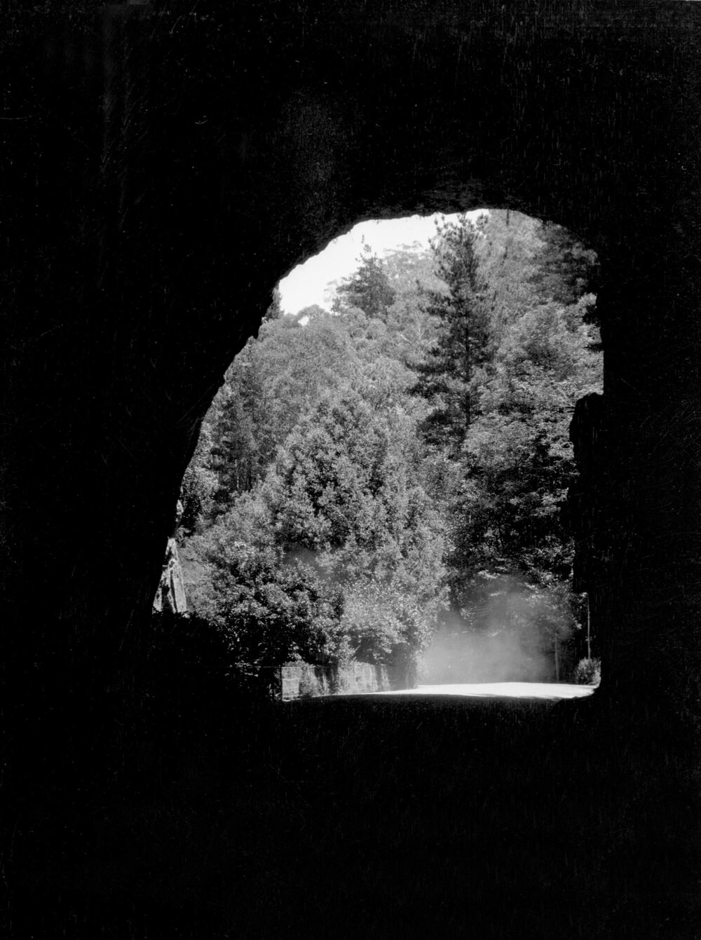 An unidentified scene viewed through a tunnel, possibly in New South Wales