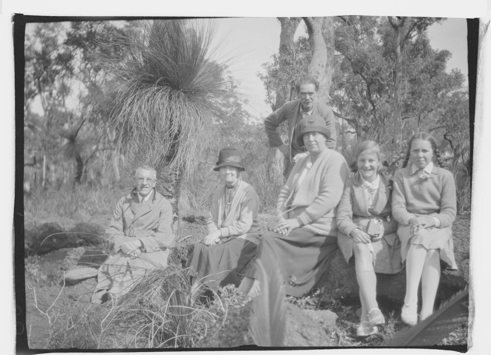A  posed group of six unidentified people in a bushland setting