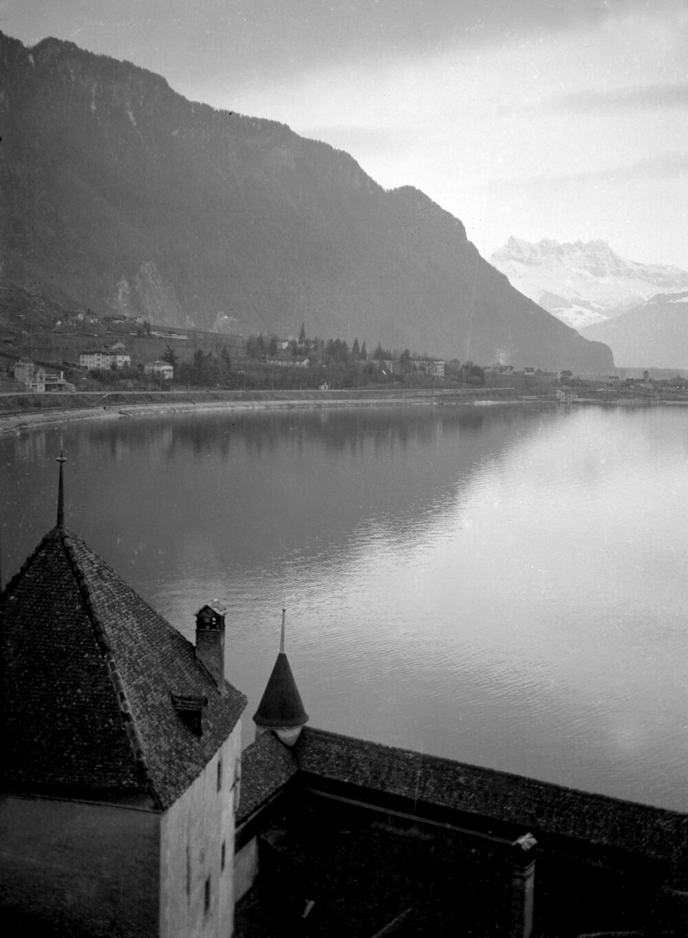 Unidentified lake, buildings and mountains