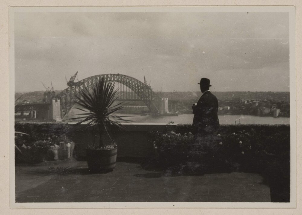 [View from rooftop courtyard of Sydney Harbour Bridge under construction]