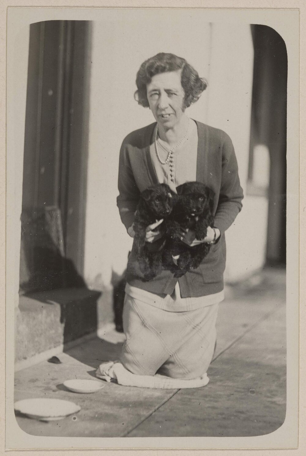 [Mabel Grimwade and puppies in basket] Miegunyah