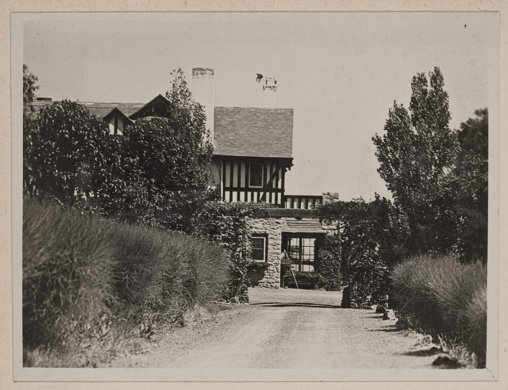 [Long lanscaped driveway,] Marathon
