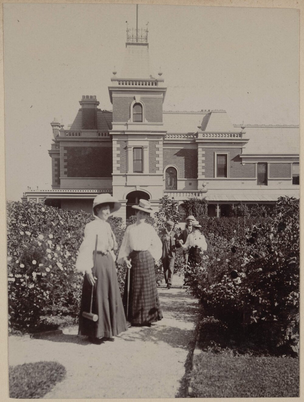 Women and men on garden path, Coolart House