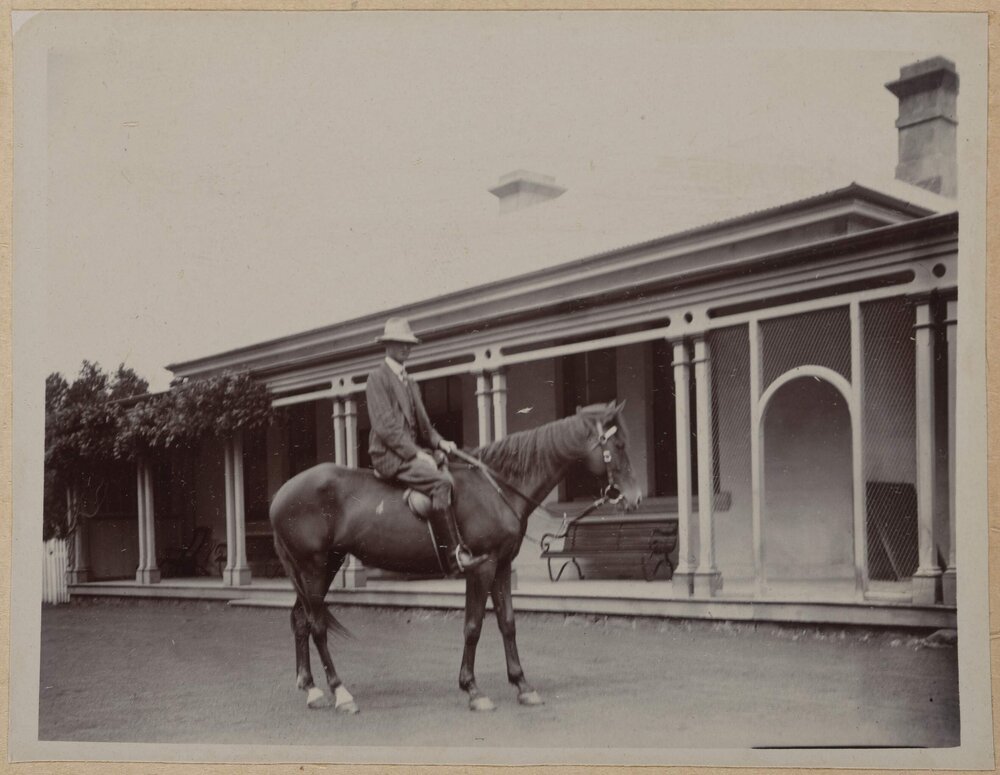 [Man wearing hat sitting on horse]