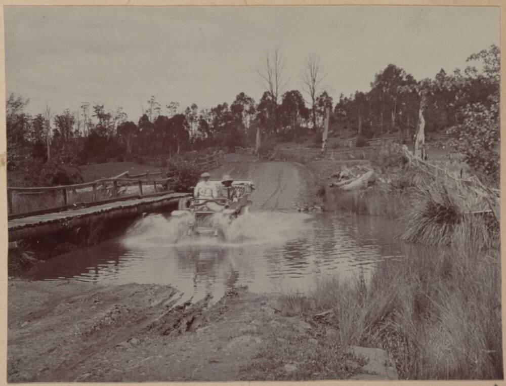 [Car driving through river]