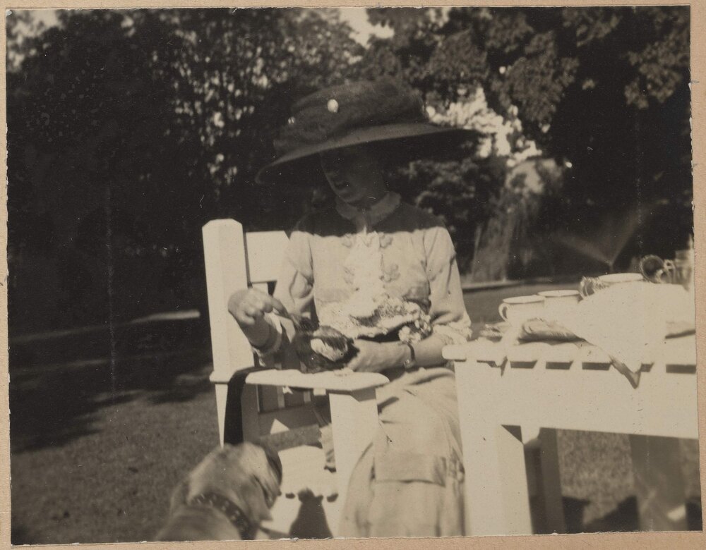 [Woman seated in garden]