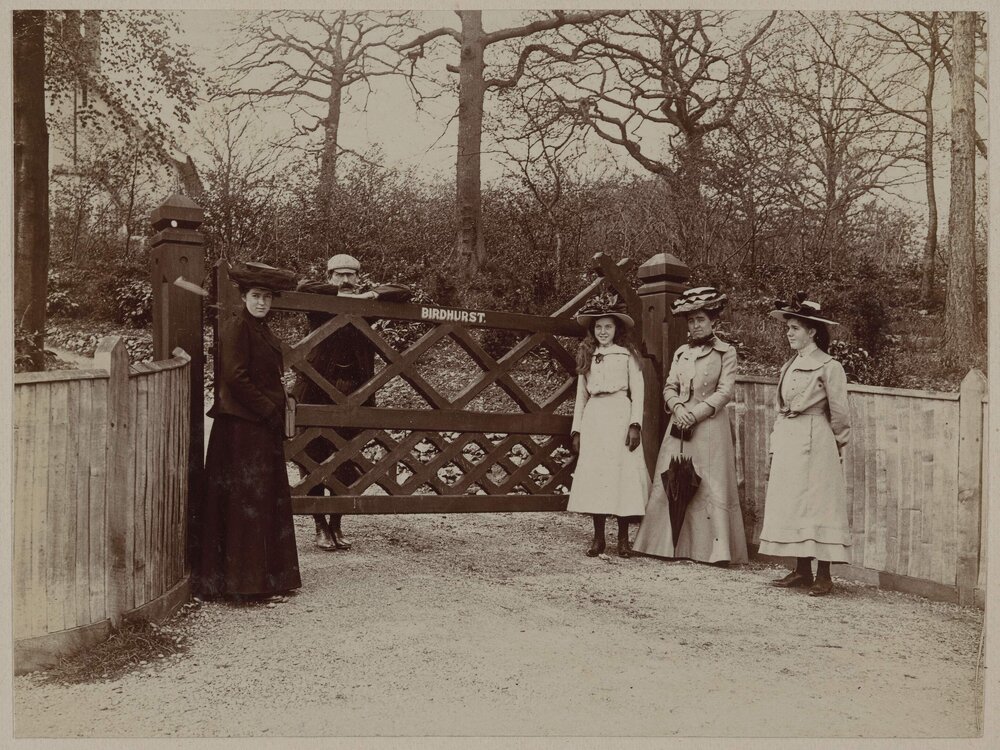[Group standing at gate marked 'Birdhurst']