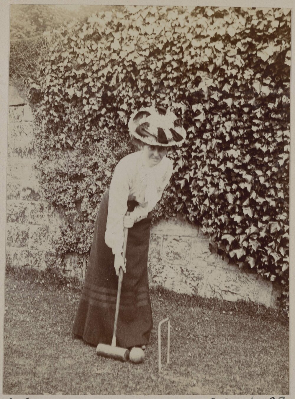 [Woman playing croquet]