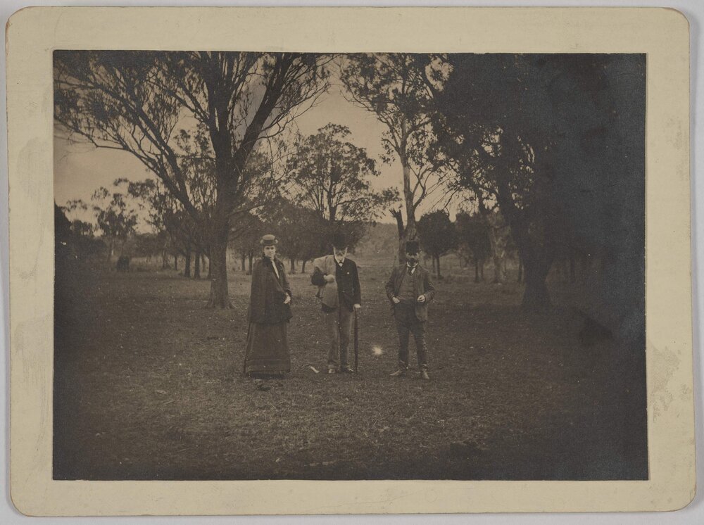 [Group photo of unidentified woman and two men]