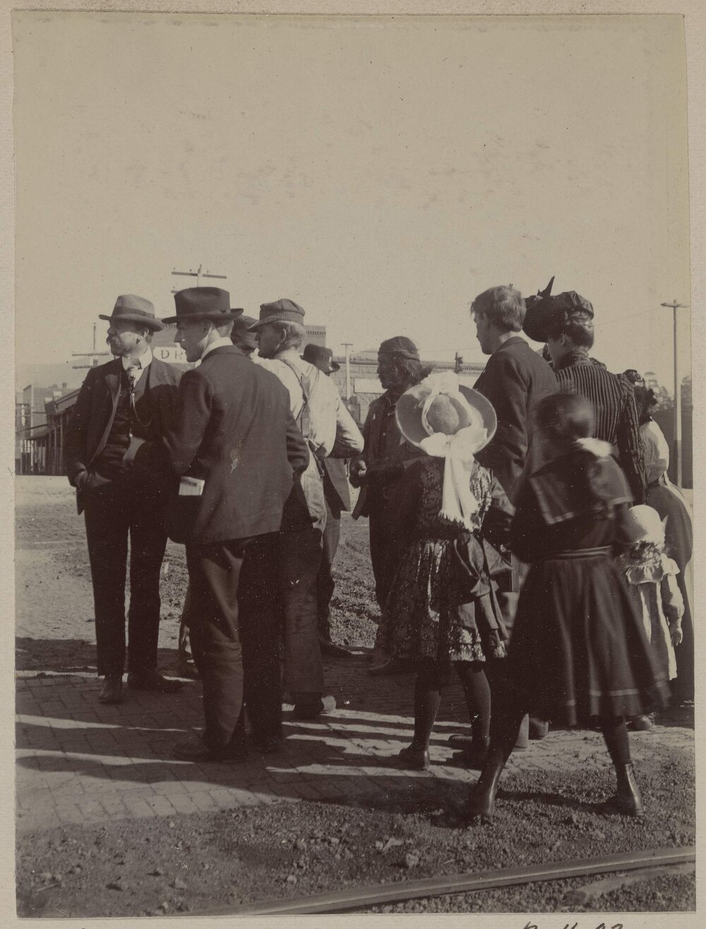 [Crowd of men, women and children]