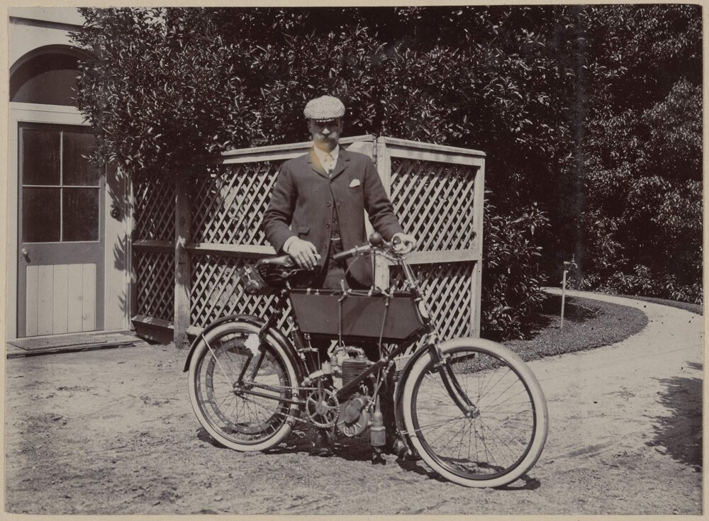 [Man posing with bicycle]
