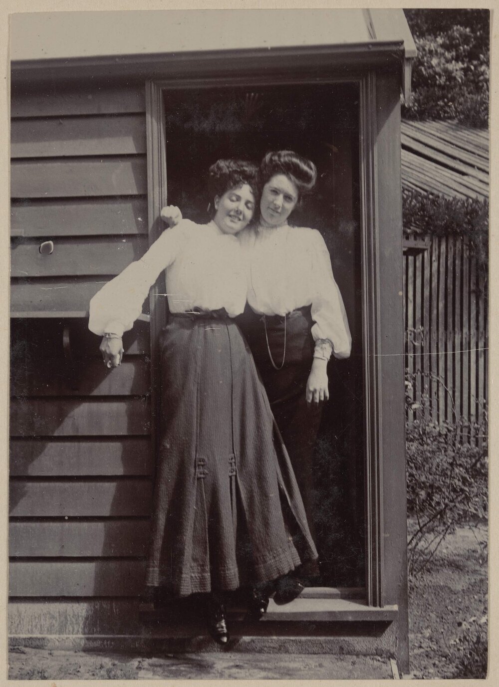 [Two women posing in doorway]