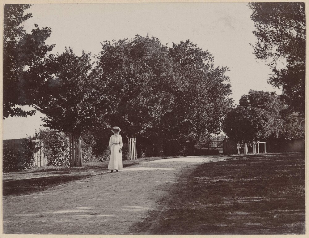 [Woman standing in driveway at Coolart]