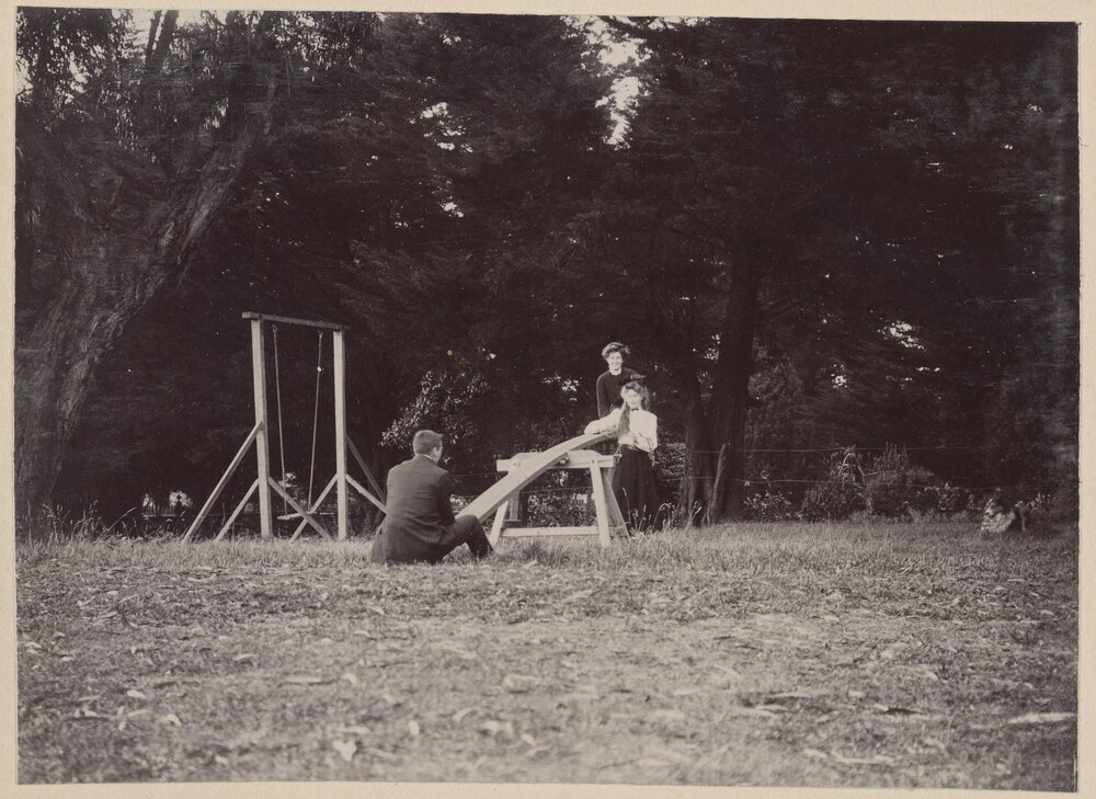 [Man and two women on seesaw]