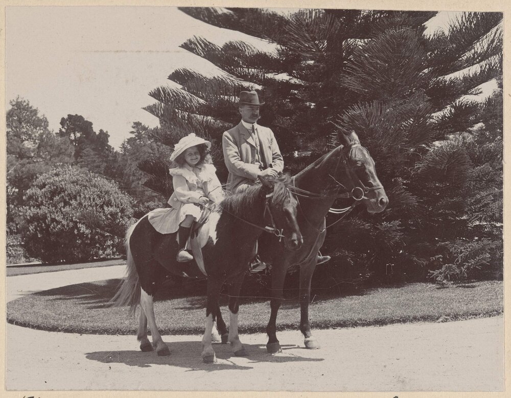 [Man and young girl mounted on horses]