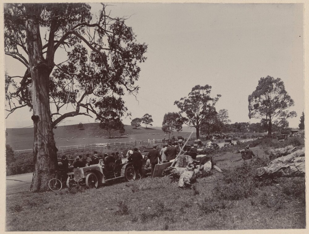 [Group of people watching motor vehicle race]