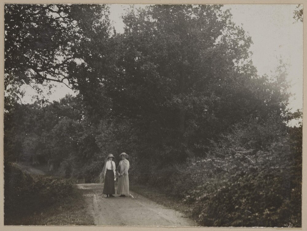 [Two women on path facing camera]