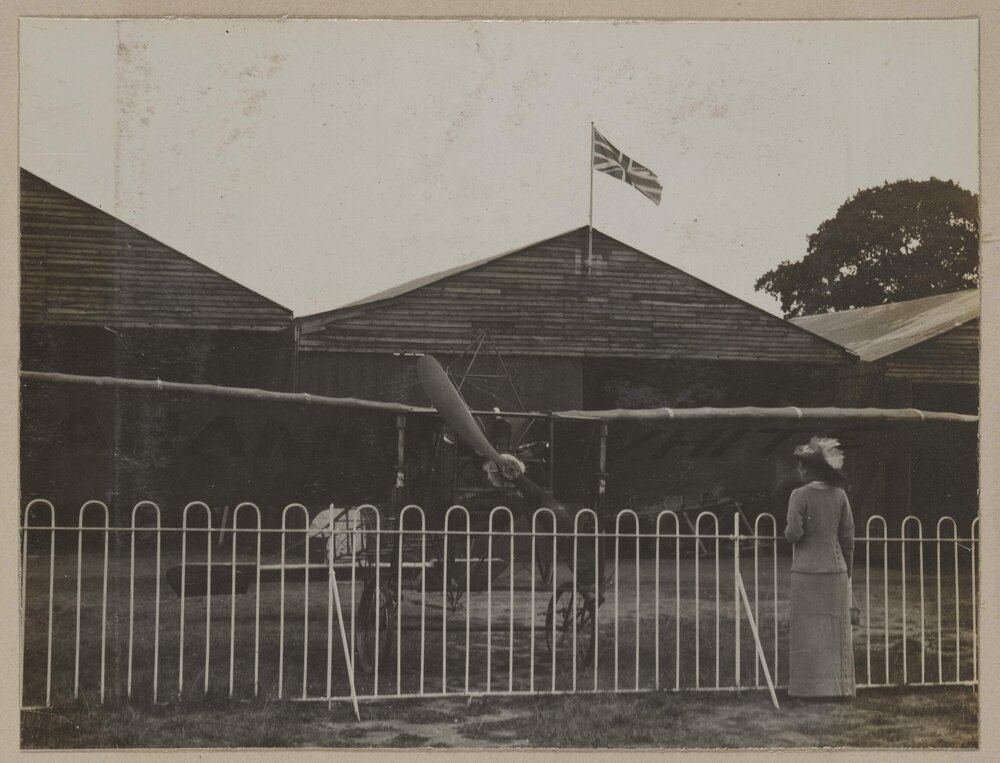 [Woman inspecting airplane]