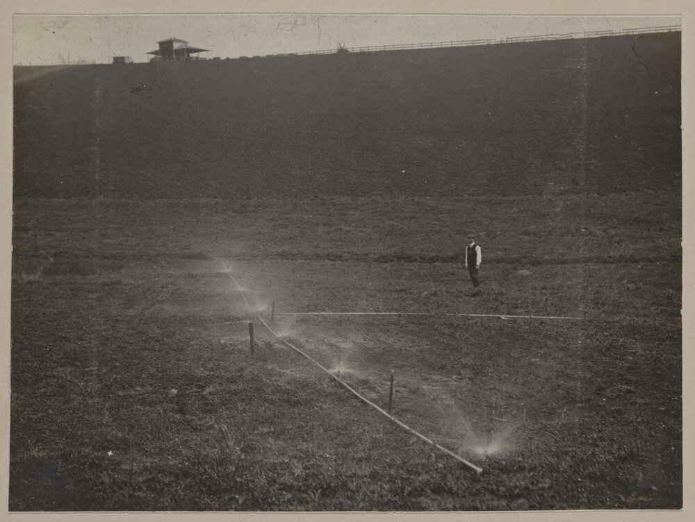 [Man observing irrigation system, Emerald Farm]