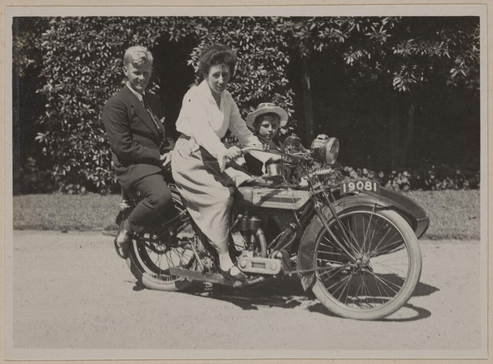 [Woman with two children on motorcycle with side car]