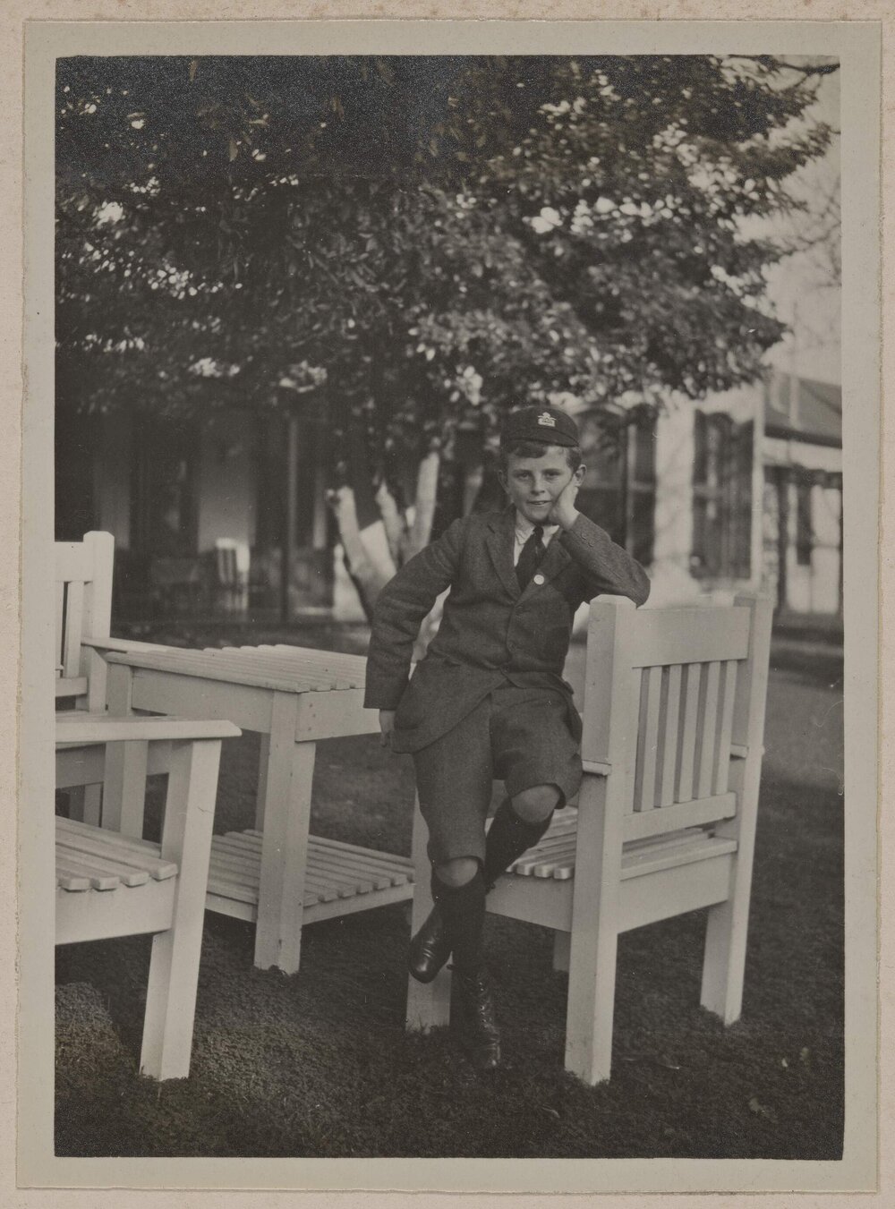 Miegunyah [young boy seated on garden chair]