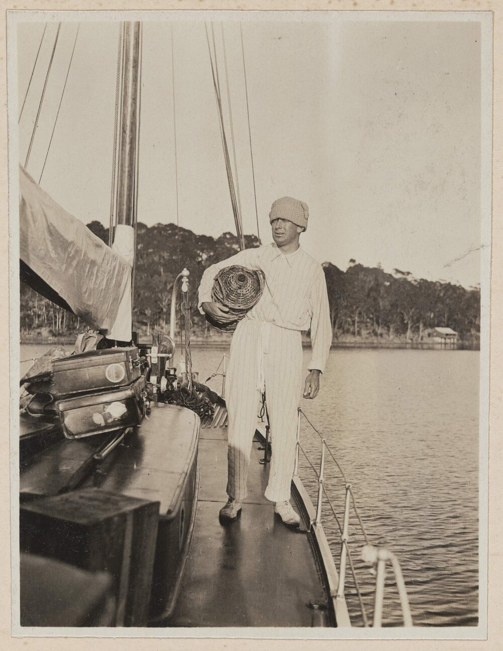 [Man standing on deck of yacht]