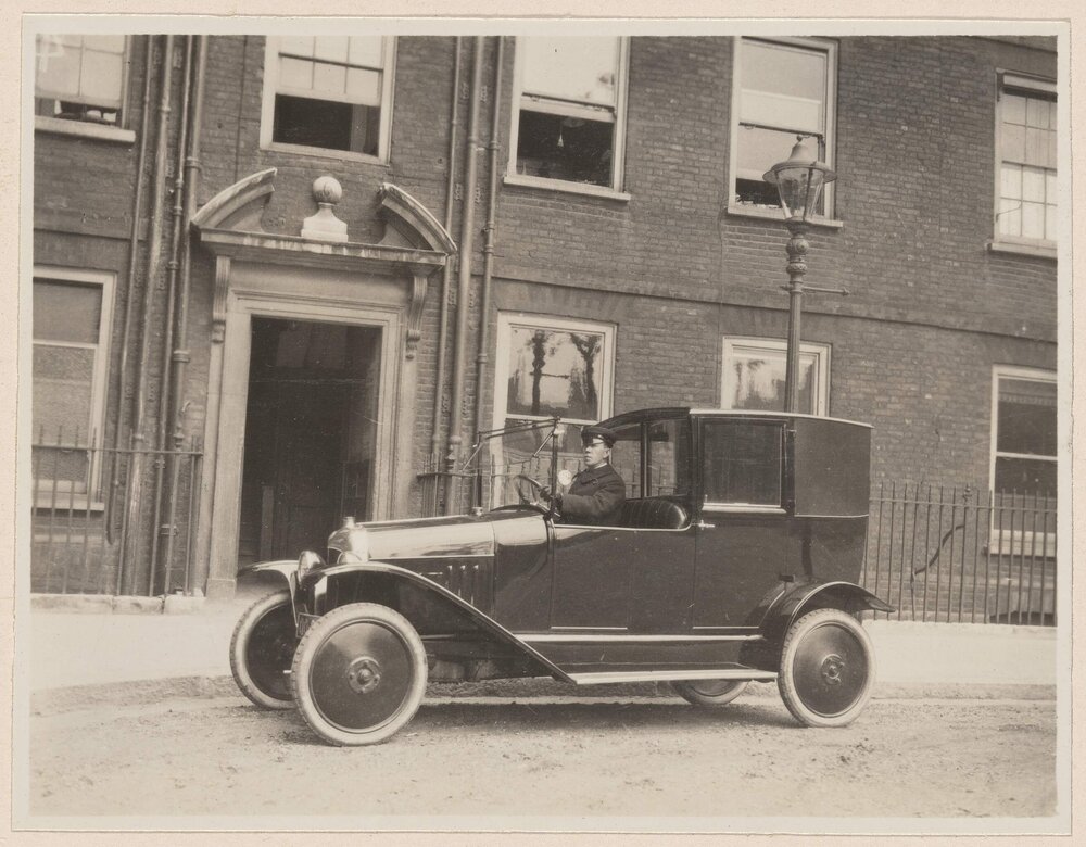 [Chauffeur seated in Coup de Ville]